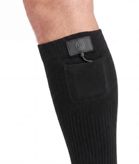 ColdCarve heated socks in black, the battery in its pocket above the boot