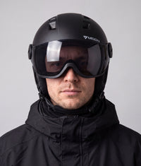 A man wearing the ColdCarve visor helmet in black, visor down