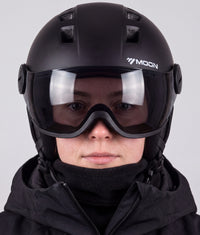 A woman wearing the ColdCarve visor helmet in black, visor down