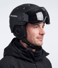 A man wearing the ColdCarve visor helmet in black, side view